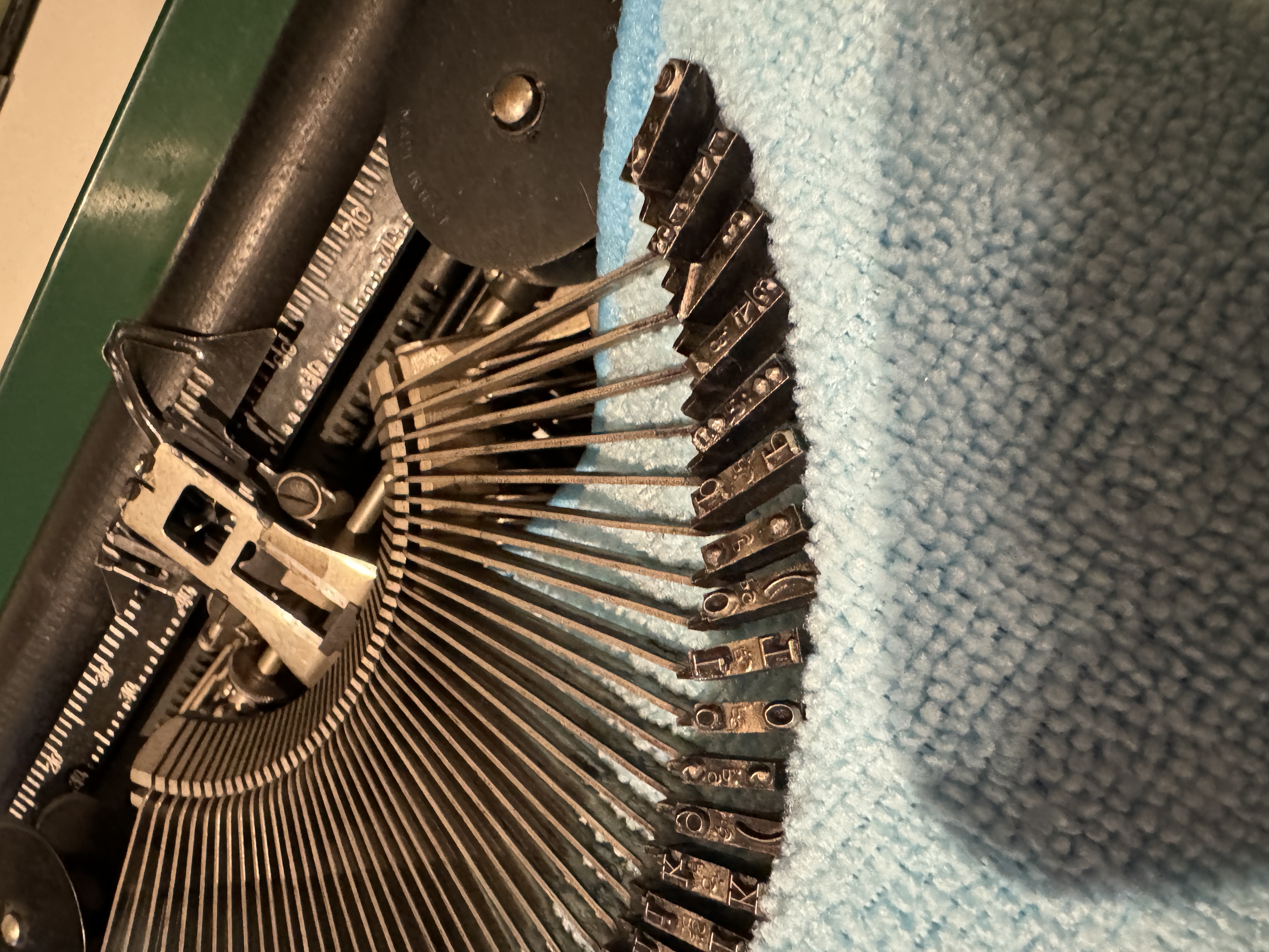 Typewriter typebars laid out for cleaning