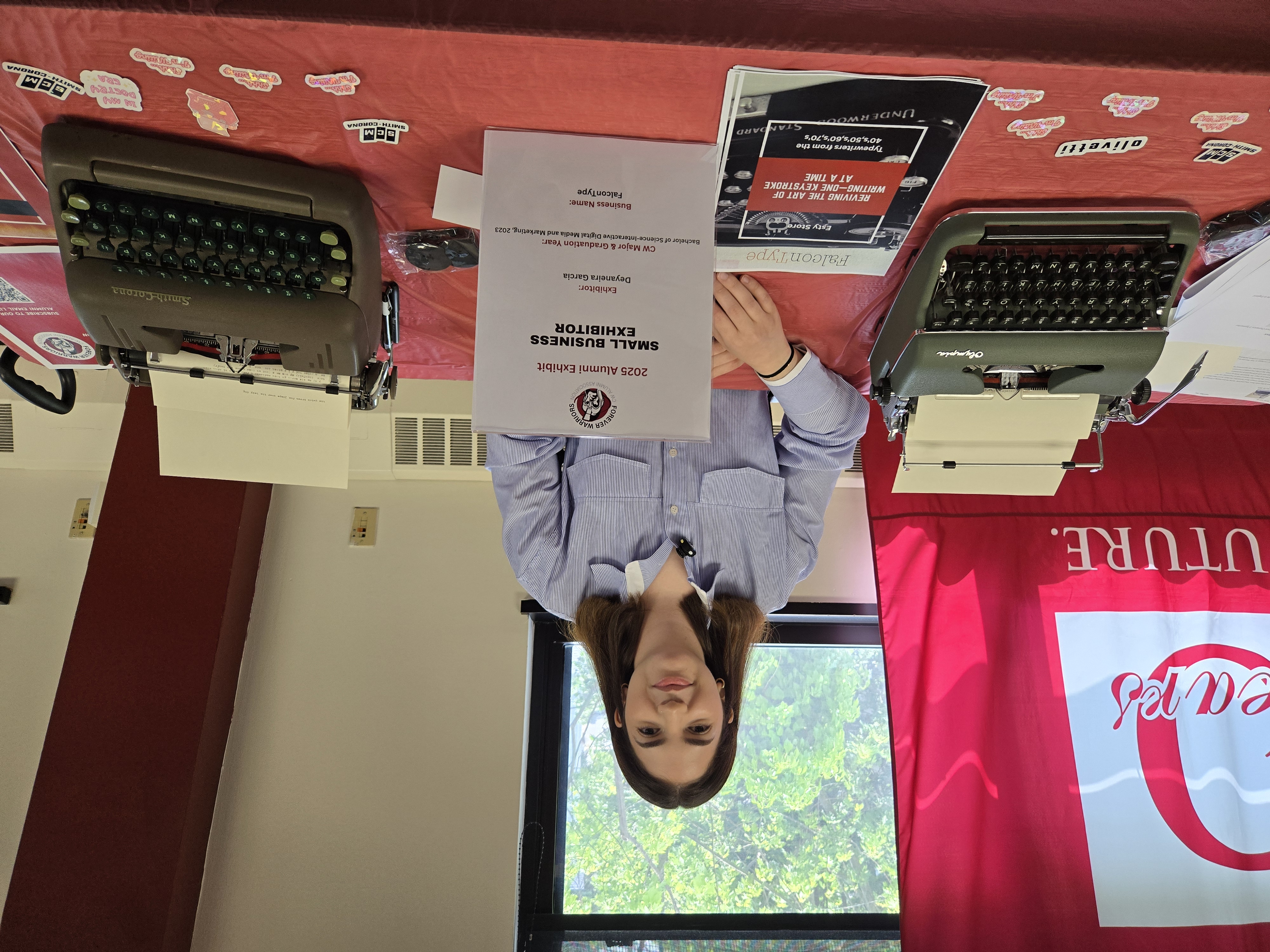 Deyaneira Garcia, owner of FalconType, at a college exhibition with vintage typewriters